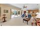 Comfortable living room with sliding glass doors to screened in patio and pool at 9612 Old Hyde Park Pl, Bradenton, FL 34202