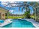 Outdoor pool and spa under a screened enclosure with a serene view of the lake at 9612 Old Hyde Park Pl, Bradenton, FL 34202