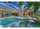 Outdoor living space featuring a sparkling pool, spa, and comfortable seating area for entertaining and relaxation at 9612 Old Hyde Park Pl, Bradenton, FL 34202