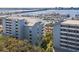 Aerial view of condos with a marina, a bridge in the background, and lush landscaping at 1000 Riverside Dr # B102, Palmetto, FL 34221