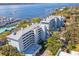 Aerial view of waterfront condos with a marina, boats, and the intercoastal waterway at 1000 Riverside Dr # B102, Palmetto, FL 34221