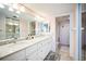 Well-lit bathroom with double sink vanity, decorative hardware, and separate shower room at 1000 Riverside Dr # B102, Palmetto, FL 34221