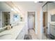 Bathroom with dual sinks, granite counters, and adjacent toilet and shower rooms at 1000 Riverside Dr # B102, Palmetto, FL 34221