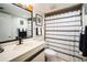 Bathroom with a single sink vanity, toilet, and shower with a black and white shower curtain at 1000 Riverside Dr # B102, Palmetto, FL 34221