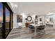 Contemporary dining room with sleek furnishings, water view, and view into main bedroom at 11 Sunset Dr # 704, Sarasota, FL 34236