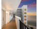 Exterior hallway view with a glimpse of the water in the distance at 11 Sunset Dr # 704, Sarasota, FL 34236