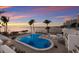Inviting outdoor pool area with palm trees, lounge chairs, and ocean views, perfect for relaxation at 11 Sunset Dr # 704, Sarasota, FL 34236