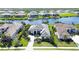 Stunning aerial view of the home nestled within a waterfront community with lush landscaping and private docks at 11511 Harbourside Ln, Parrish, FL 34219