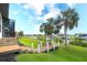 Scenic backyard view featuring a wooden walkway leading to a dock, with lush landscaping and waterfront access at 11511 Harbourside Ln, Parrish, FL 34219