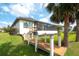 Backyard with waterfront access showcasing a wooden walkway with dock access and an inviting screened in lanai at 11511 Harbourside Ln, Parrish, FL 34219