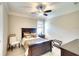 Comfortable bedroom with a dark wood bed frame, neutral walls, light-colored floors, and a ceiling fan at 11511 Harbourside Ln, Parrish, FL 34219
