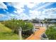 Private boat dock with lush shoreline, providing direct water access and scenic views for boating enthusiasts at 11511 Harbourside Ln, Parrish, FL 34219
