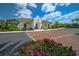 Beautiful exterior view of a home featuring a brick paved driveway, stucco facade, and manicured landscaping at 11511 Harbourside Ln, Parrish, FL 34219