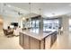 Elegant kitchen with a large center island, open to the living room and dining area, perfect for entertaining at 11511 Harbourside Ln, Parrish, FL 34219