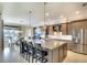 Modern kitchen with a large center island, granite countertops, stainless steel appliances, and ample cabinet space at 11511 Harbourside Ln, Parrish, FL 34219