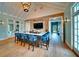 A modern kitchen featuring a brick wall, an island with chairs, and access to the outside at 11511 Harbourside Ln, Parrish, FL 34219