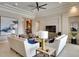 Open-concept living room with stylish decor, neutral color scheme, and abundant natural light from large windows at 11511 Harbourside Ln, Parrish, FL 34219