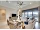 Cozy living room with comfortable seating, a decorative fireplace, and large windows offering serene backyard views at 11511 Harbourside Ln, Parrish, FL 34219