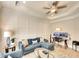 Cozy living room boasts modern decor, tray ceiling, and a comfortable blue sofa at 11511 Harbourside Ln, Parrish, FL 34219