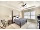 Serene main bedroom features a tray ceiling, plantation shutters, and an elegant four-poster bed at 11511 Harbourside Ln, Parrish, FL 34219