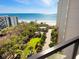 Balcony with an elevated view of lush landscape, pristine beach, and ocean at 1211 Gulf Of Mexico Dr # 702, Longboat Key, FL 34228