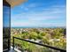 Balcony overlooking a residential area and a distant ocean view at 1211 Gulf Of Mexico Dr # 702, Longboat Key, FL 34228