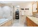 Elegant bathroom with a soaking tub, a large mirror, and a walk-in shower with a glass door at 1211 Gulf Of Mexico Dr # 702, Longboat Key, FL 34228
