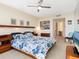 Inviting bedroom featuring a queen-sized bed, soft carpeting, and a full entertainment center at 1211 Gulf Of Mexico Dr # 702, Longboat Key, FL 34228