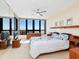 Comfortable bedroom with a queen-sized bed, large windows boasting stunning views, and ample storage at 1211 Gulf Of Mexico Dr # 702, Longboat Key, FL 34228