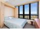Cozy bedroom boasts a built-in Murphy bed and large windows offering breathtaking ocean views at 1211 Gulf Of Mexico Dr # 702, Longboat Key, FL 34228