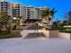 Elegant condo exterior with well-manicured grounds, illuminated pathways, and inviting entrance steps at 1211 Gulf Of Mexico Dr # 702, Longboat Key, FL 34228