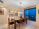 Dining room with stylish table and chairs, built-in shelving, and a scenic ocean view through the window at 1211 Gulf Of Mexico Dr # 702, Longboat Key, FL 34228