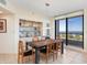 Comfortable dining area with sleek table, display case, and large window offering beautiful water views at 1211 Gulf Of Mexico Dr # 702, Longboat Key, FL 34228