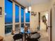 Cozy dining area with modern light fixtures, a round table, and expansive windows with a spectacular view at 1211 Gulf Of Mexico Dr # 702, Longboat Key, FL 34228