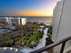 Exterior view of the property highlighting beautifully landscaped grounds and oceanfront views with a stunning sunset at 1211 Gulf Of Mexico Dr # 702, Longboat Key, FL 34228