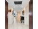 Inviting hallway with neutral tones, tiled flooring, and decorative artwork leading into the condo at 1211 Gulf Of Mexico Dr # 702, Longboat Key, FL 34228
