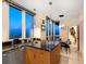 Modern kitchen with a center island featuring elegant granite counters, wooden cabinets, and scenic views from the windows at 1211 Gulf Of Mexico Dr # 702, Longboat Key, FL 34228