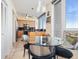 Open kitchen and dining area featuring stainless steel appliances, a black marble backsplash, and breakfast nook with views at 1211 Gulf Of Mexico Dr # 702, Longboat Key, FL 34228