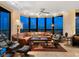 Spacious living room with comfortable seating, a ceiling fan, and floor-to-ceiling windows with a stunning view at 1211 Gulf Of Mexico Dr # 702, Longboat Key, FL 34228