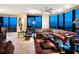 Comfortable living room featuring a large sectional, recliner, and a large window with city views and ceiling lighting at 1211 Gulf Of Mexico Dr # 702, Longboat Key, FL 34228