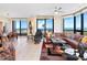 Living room with sweeping views of the ocean, a leather couch, and modern decor at 1211 Gulf Of Mexico Dr # 702, Longboat Key, FL 34228
