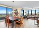 Living room boasts floor-to-ceiling windows with water views, stylish decor, and plenty of natural light at 1211 Gulf Of Mexico Dr # 702, Longboat Key, FL 34228