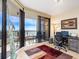 Cozy office space with a desk, chair, and a sliding door to a balcony with water views at 1211 Gulf Of Mexico Dr # 702, Longboat Key, FL 34228
