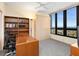 Bright office space featuring built-in shelves, a large desk, and stunning ocean views from the expansive windows at 1211 Gulf Of Mexico Dr # 702, Longboat Key, FL 34228