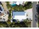 Birds-eye view of the property, surrounded by lush landscaping, nearby pool, and white sandy beaches at 123 Hammock Rd, Anna Maria, FL 34216