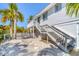 Charming backyard features a white picket fence, steps and tropical foliage at 123 Hammock Rd, Anna Maria, FL 34216