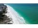 Expansive shoreline view of a sun-kissed beach with crystal-clear turquoise waters at 123 Hammock Rd, Anna Maria, FL 34216