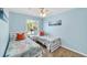 Bright bedroom featuring twin beds, complemented by sunlight streaming through the windows at 123 Hammock Rd, Anna Maria, FL 34216