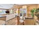 Bright dining room with a chandelier, a glass table, and wicker chairs, offering access to the outdoor patio at 123 Hammock Rd, Anna Maria, FL 34216