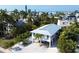 Bright, modern stilt home with metal roof, and lush tropical landscaping on a beautiful Florida beach at 123 Hammock Rd, Anna Maria, FL 34216